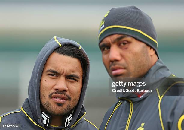 Digby Ioane and Wycliff Palu of the Wallabies look on during an Australian Wallabies training session at Visy Park on June 24, 2013 in Melbourne,...