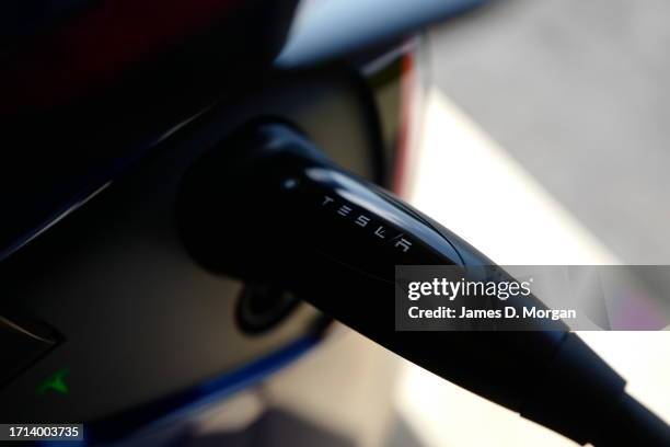 Model Y car sits inside a home garage whilst receiving a top up charge of solar powered electricity on October 03, 2023 in Ballina, Australia.