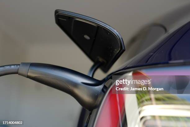 Model Y car sits inside a home garage whilst receiving a top up charge of solar powered electricity on October 03, 2023 in Ballina, Australia.