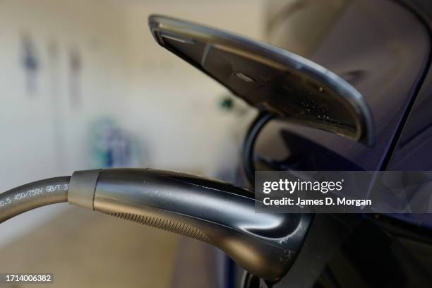 Model Y car sits inside a home garage whilst receiving a top up charge of solar powered electricity on October 03, 2023 in Ballina, Australia.