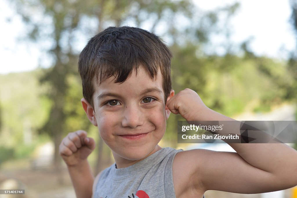 Boy showing his muscles