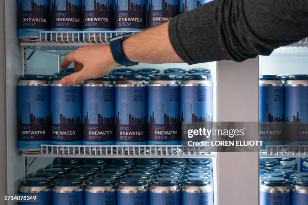 Aaron Tartakovsky, co-founder and CEO of water technology startup Epic Cleantec, reaches into a refrigerator of beers brewed with recycled wastewater...