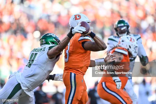 New York Jets linebacker Jermaine Johnson sets to force a fumble as Denver Broncos quarterback Russell Wilson attempts a pass during a game between...