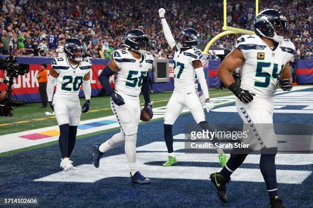 Jordyn Brooks of the Seattle Seahawks celebrates his fumble recover with teammates during the first quarter against the New York Giants at MetLife...
