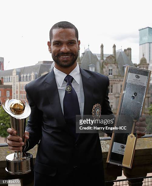 Player of the Tournament' Shikhar Dhawan poses with his awards during a photocall for the winners of the ICC Champions Trophy on June 24, 2013 in...