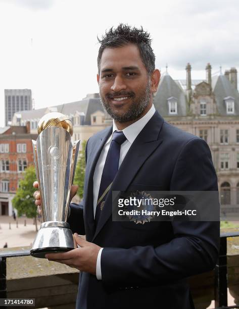 Indian captain MS Dhoni poses with the Champions Tophy during a photocall for the winners of the ICC Champions Trophy on June 24, 2013 in Birmingham,...