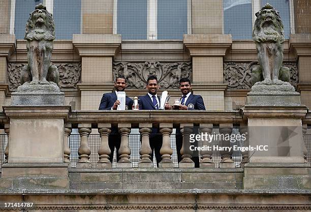 Player of the Tournament' Shikhar Dhawan, India captain MS Dhoni and 'Man of the Match' Ravindra Jadeja pose with their respective trophies during a...