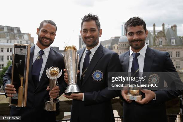 Player of the Tournament' Shikhar Dhawan, India captain MS Dhoni and 'Man of the Match' Ravindra Jadeja pose with their respective trophies during a...