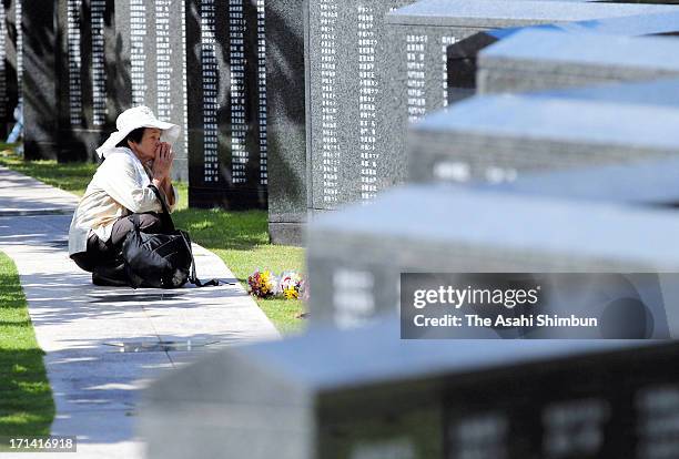 Woman prays for the war dead in front of Heiwa-no-Ishiji or 'Cornerstone of Peace', the memorial to commemorate Okinawa-related war victims, at...