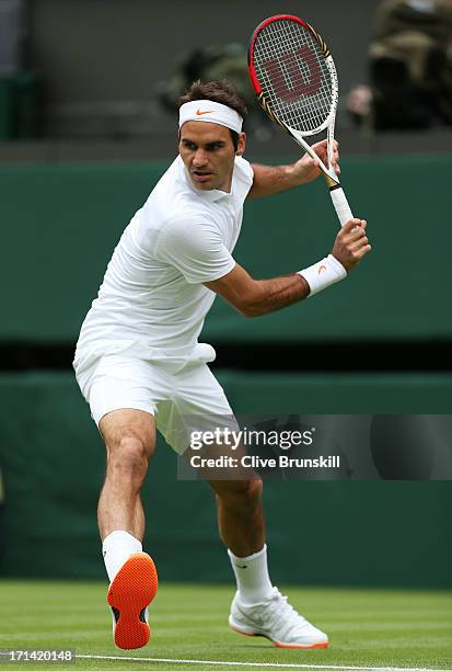 Roger Federer of Switzerland plays a backhand in his gentlemen's singles first round match against Victor Hanescu of Romania on day one of the...