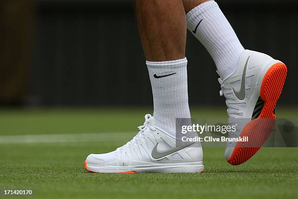 Roger Federer of Switzerland' trainers during his gentlemen's singles first round match against Victor Hanescu of Romania on day one of the Wimbledon...
