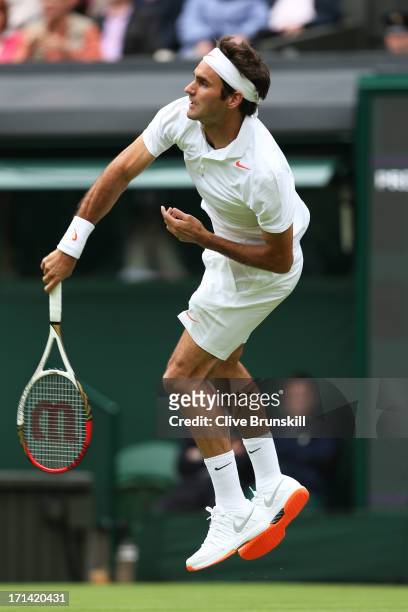 Roger Federer of Switzerland serves during his gentlemen's singles first round match against Victor Hanescu of Romania on day one of the Wimbledon...