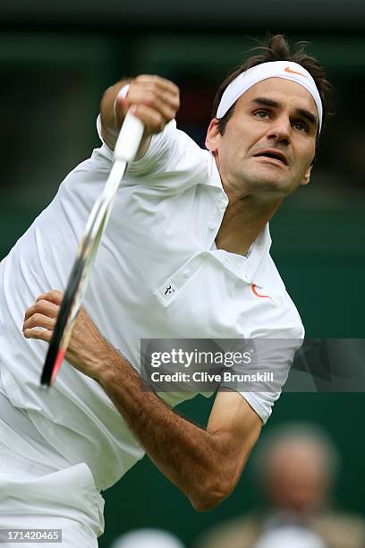 Roger Federer of Switzerland serves during his gentlemen's singles first round match against Victor Hanescu of Romania on day one of the Wimbledon...