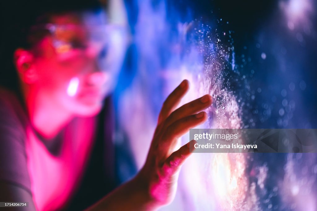 A person touching the digital interface. Interaction with the unknown and cosmic exploration
