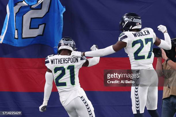 Devon Witherspoon of the Seattle Seahawks celebrates his interception return for a touchdown with Riq Woolen during the third quarter against the New...