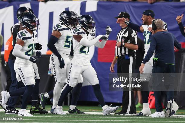 Devon Witherspoon of the Seattle Seahawks celebrates his interception return for a touchdown with teammates during the third quarter against the New...