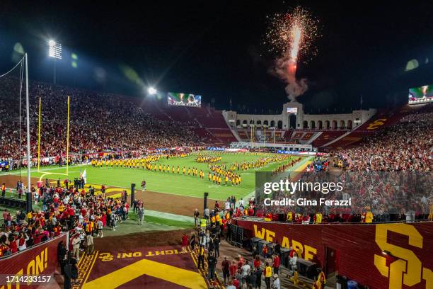 Fireworks flare into the night sky as the Trojan marching band plays the National Anthem before USC's game against Arizona at the LA Memorial...