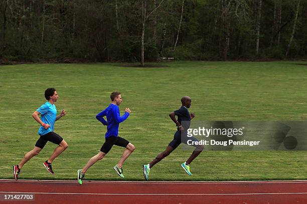 Cam Levins of Canada, Galen Rupp of the USA and Mo Farah of Great Britain, members of the Oregon Project, train on the track at the Nike campus on...