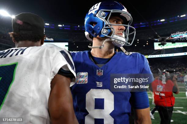 Daniel Jones of the New York Giants shakes hands with Geno Smith of the Seattle Seahawks following the game at MetLife Stadium on October 02, 2023 in...