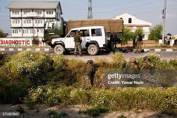 Indian army soldiers take positions after their convoy was attacked by militants on June 24, 2013 in Srinagar, the summer capital of Indian...