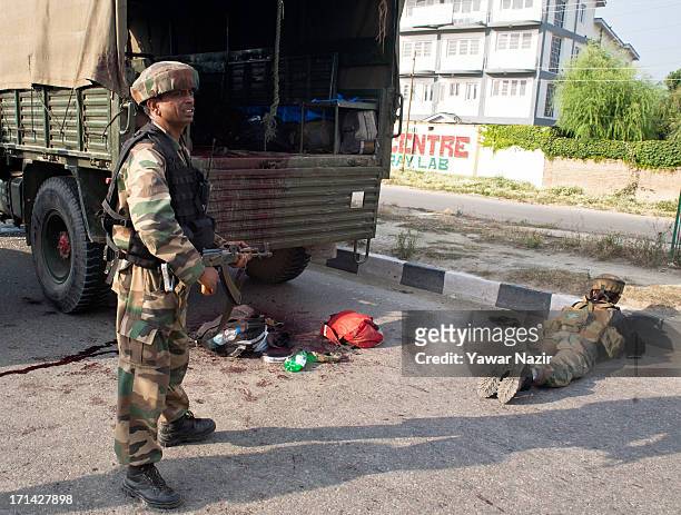 Indian army soldiers take positions after their convoy was attacked by militants on June 24, 2013 in Srinagar, the summer capital of Indian...