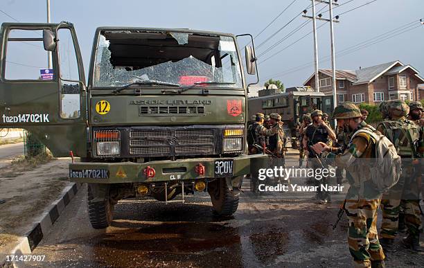 An Indian army soldier takes pictures of an army vehicle which came under the attack of militants on June 24, 2013 in Srinagar, the summer capital of...