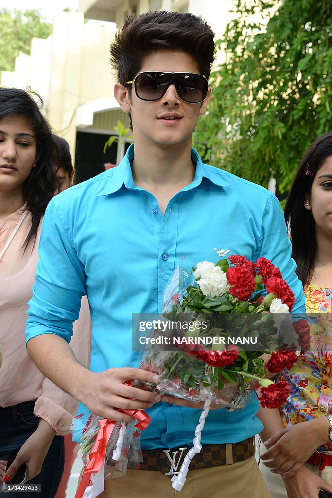Actor Rohan Mehra Indian actor Rohan Mehra receives flowers from fans as he arrives to ...