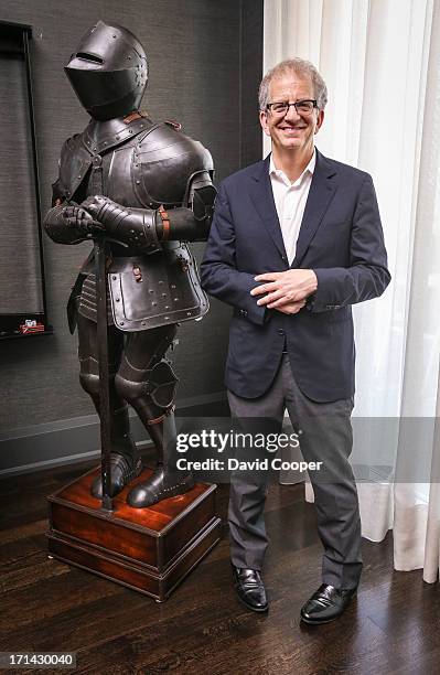 Ken Metrick mimics a pigeon toed suit of armour as he stands beside it. Ken and Renee Metrick owners of Elte one of the world's finest home...