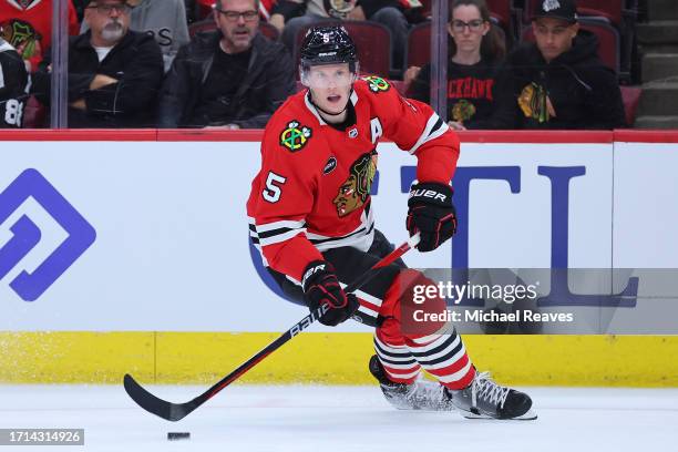 Connor Murphy of the Chicago Blackhawks skates with the puck against the St. Louis Blues during the first period of a preseason game at the United...