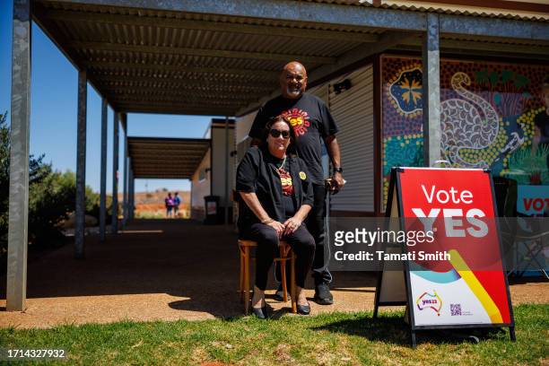 Campaigners sit out the front of the voting booth on October 03, 2023 in Yalgoo, Australia. A referendum for Australians to decide on an indigenous...