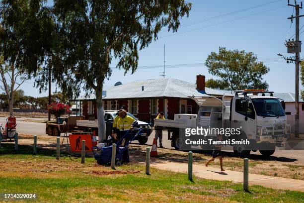 Shire workers fix a path as a young child runs by October 03, 2023 in Yalgoo, Australia. A referendum for Australians to decide on an indigenous...