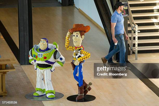 "Toy Story" character cut-outs stand as people walk in the halls at the Pixar Animation Studios headquarters in Emeryville, California, U.S., on...
