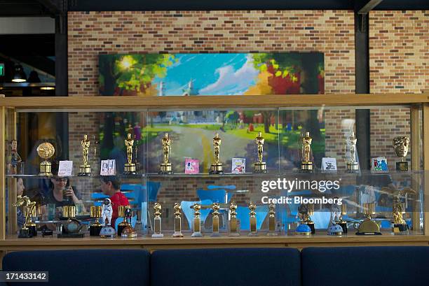 Award statues are displayed inside the lobby and cafeteria area at the Pixar Animation Studios headquarters in Emeryville, California, U.S., on...