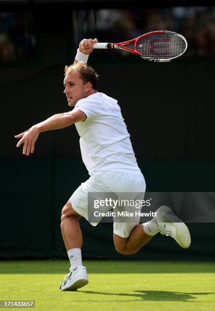 Steve Darcis of Belgium hits a forehand during his Gentlemen's Singles first round match against Rafael Nadal of Spain on day one of the Wimbledon...