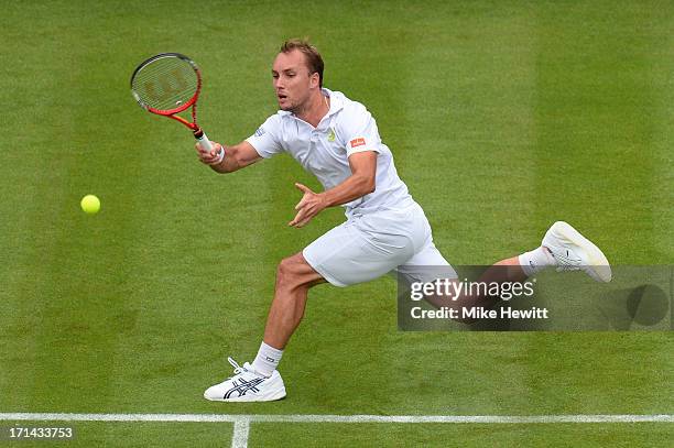 Steve Darcis of Belgium hits a forehand during his Gentlemen's Singles first round match against Rafael Nadal of Spain on day one of the Wimbledon...