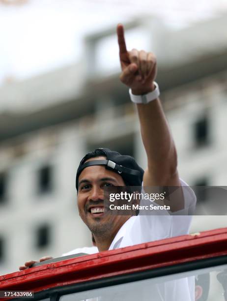 Head Coach Erik Spoelstra of the Miami Heat gestures as he rides a float during the Championship victory parade on the streets on June 24, 2013 in...