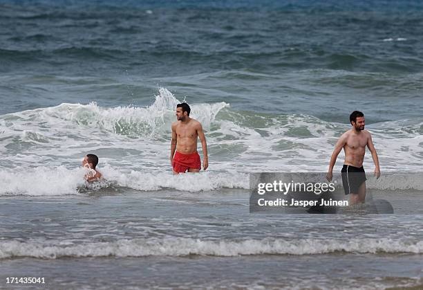 Cesc Fabregas of Spain enjoys a bath in the sea with his teammates Fernando Torres and Juan Mata at the Playa Futuro on June 24, 2013 in Fortaleza,...