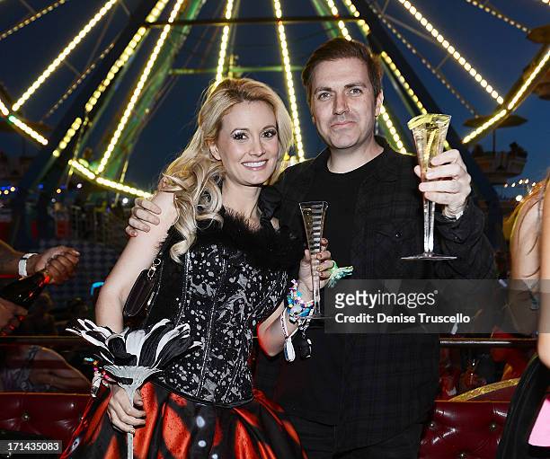 Holly Madison and Pasquale Rotella pose for photos in front of the Ferris wheel where he asked for her hand in marriage during the 17th annual...