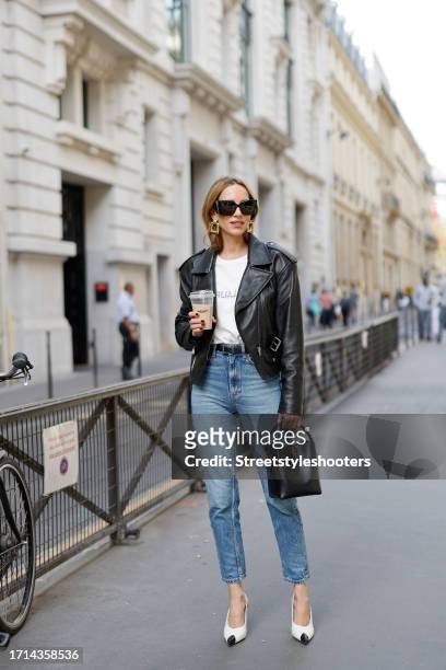 Influencer Alexandra Lapp is seen wearing SAINT LAURENT leather jacket, T-shirt, belt and sunglasses, SAINT LAURENT Le 37 bag, BOTTEGA VENETA ear...