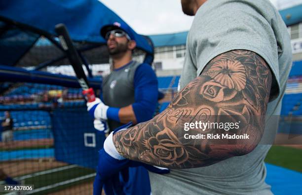 Brett Lawrie's left arm is full sleve tatto these days as outfielder Jose Bautista and he chat. Pitchers and catchers are required to report today to...