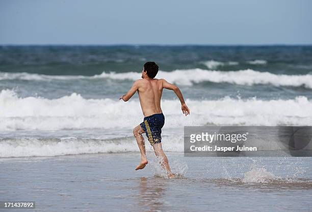 Javier Martinez of Spain runs into the sea for a bath at Playa Futuro on June 24, 2013 in Fortaleza, Brazil.