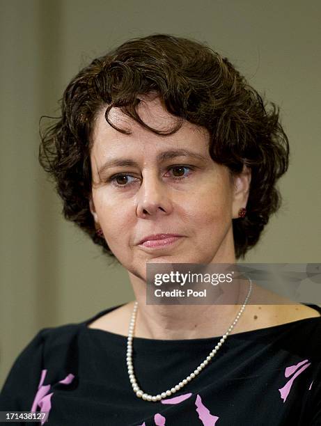 Cecilia Muñoz, Director of the Domestic Policy Council, listens as U.S. President Barack Obama makes a statement to the press prior to meeting with...