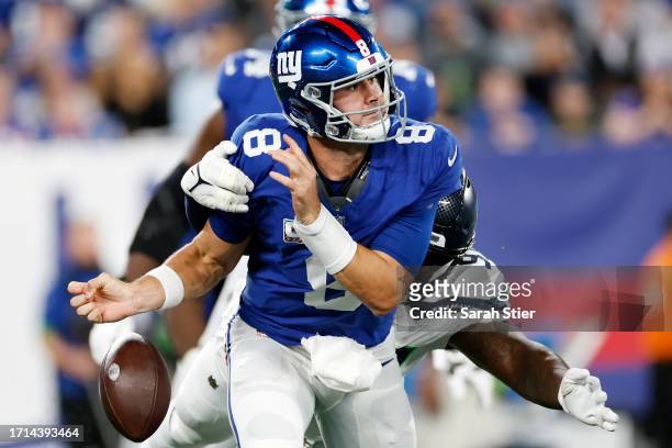 Daniel Jones of the New York Giants has the ball stripped by Mario Edwards Jr. #97 of the Seattle Seahawks during the first quarter at MetLife...