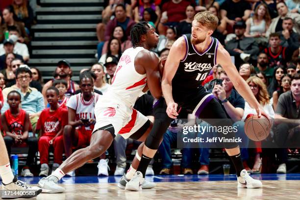 Domantas Sabonis of the Sacramento Kings handles the ball during the game against the Toronto Raptors on October 8, 2023 at the Rogers Arena in...