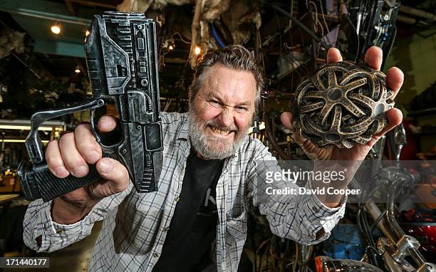 Walter Klassen holds a fantasy gun that actually fires blanks that was created on his 3D printer and a fantasy alien throwing star also 3D printed....