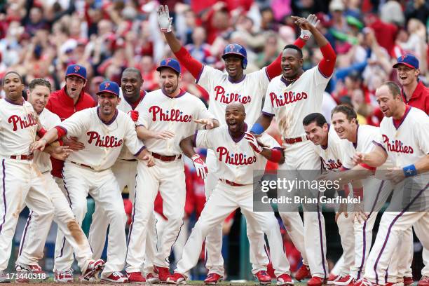 Philadelphia Phillies are seen at home plate awaiting Freddy Galvis to finish running the bases after hitting a walk off home run in the bottom of...