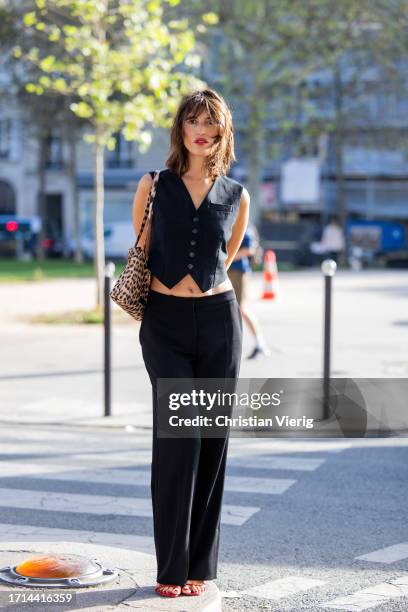 Jeanne Damas wears black vest, pants outside Stella McCartney during the Womenswear Spring/Summer 2024 as part of Paris Fashion Week on October 02,...