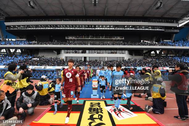 Captains Jung Woo-young of Vissel Kobe and Kengo Nakamura of Kawasaki Frontale lead teams entering the pitch prior to the J.League J1 first stage...