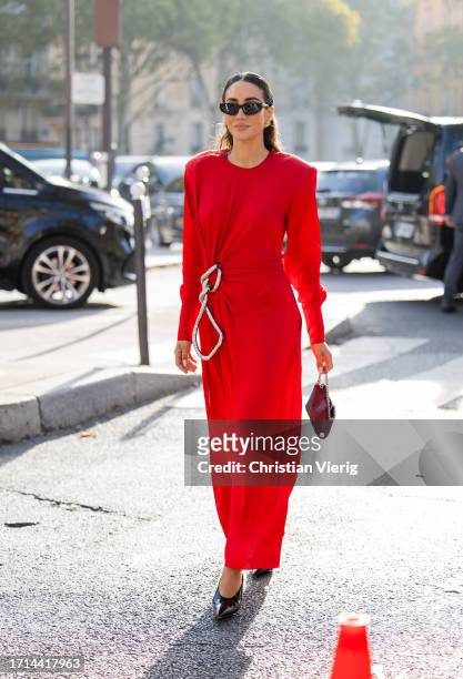 Tamara Kalinic wears red dress, black bag outside Stella McCartney during the Womenswear Spring/Summer 2024 as part of Paris Fashion Week on October...
