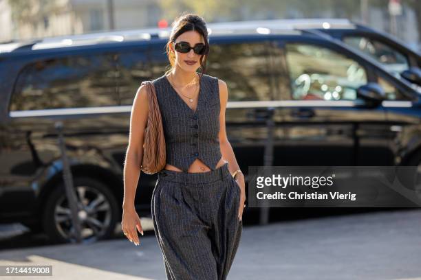 Bettina Looney wears grey vest, wide leg pants, brown bag outside Stella McCartney during the Womenswear Spring/Summer 2024 as part of Paris Fashion...